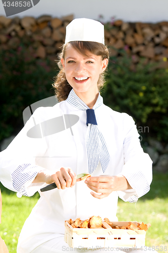 Image of female chef with chanterelle mushrooms, 