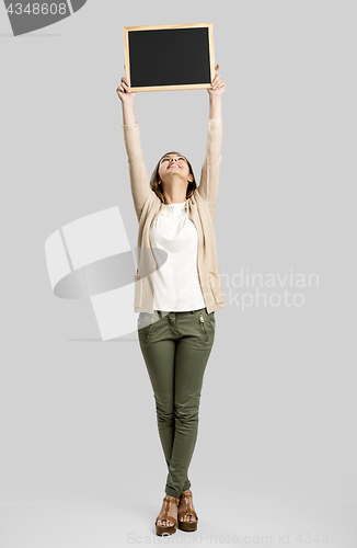 Image of Woman showing something on a chalkboard