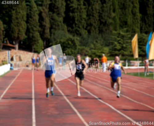 Image of Blurred view of man athletic running competition at stadium