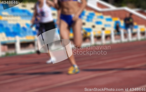 Image of Blurred view of athletic running competition at stadium not in f