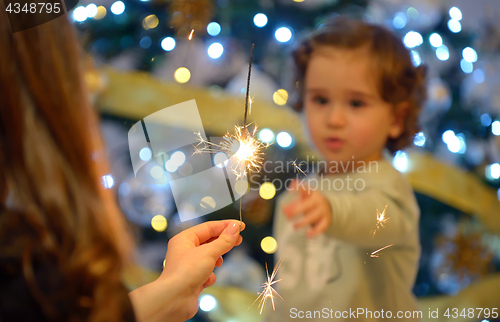 Image of Teen girl holding sparklers