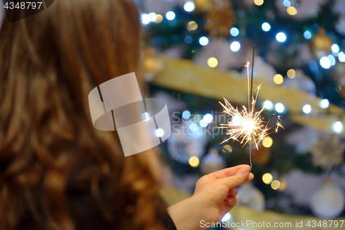 Image of Teen girl holding sparklers