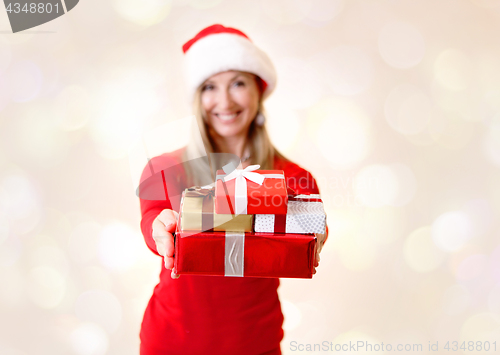 Image of Woman holding out Christmas presents Giving Christmas Spirit