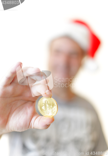 Image of Man holding a Bitcoin BTC in his hand