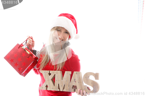 Image of Woman holding Xmas sign and shopping bags