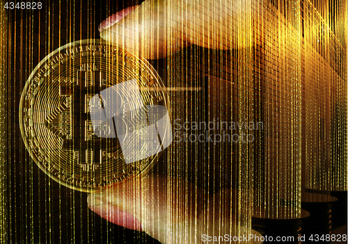 Image of Hands holding a golden Bitcoin