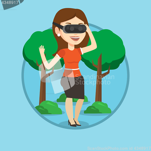 Image of Woman wearing virtual reality headset in the park.