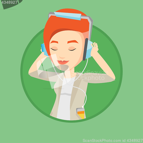 Image of Young woman in headphones listening to music.