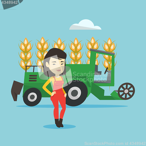 Image of Farmer standing with combine on background.