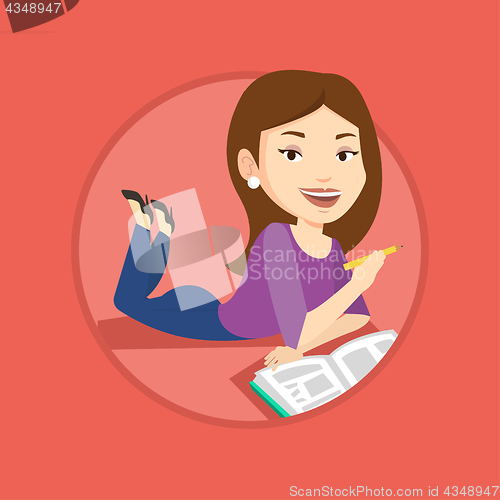 Image of Student laying on the floor and reading book.