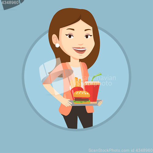 Image of Woman holding tray full of fast food.