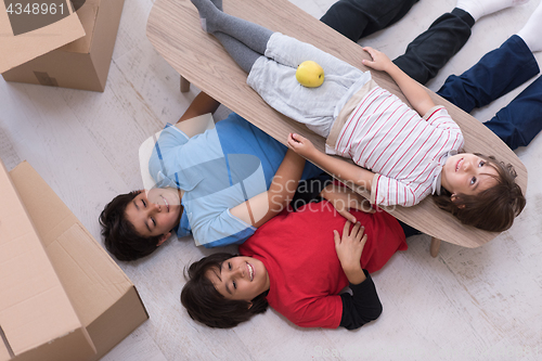 Image of boys with cardboard boxes around them top view