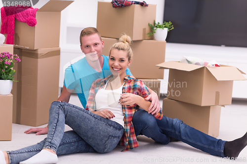 Image of young couple moving  in new house