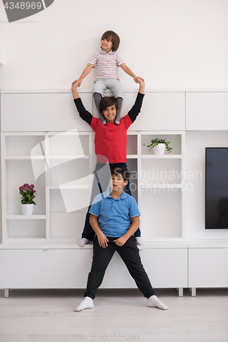 Image of young boys posing line up piggyback