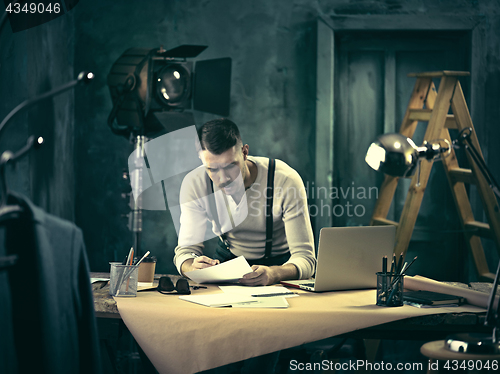 Image of Architect working on drawing table in office