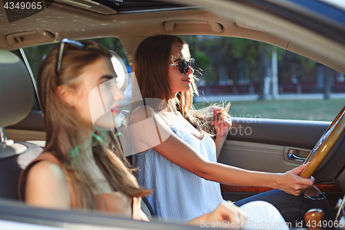 Image of young women in the car smiling