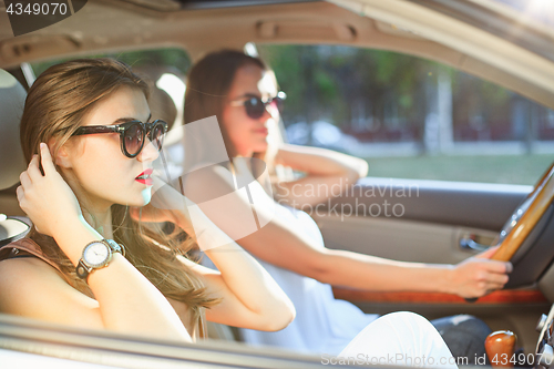 Image of young women in the car smiling