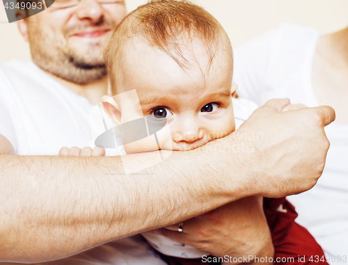 Image of father carrying clothers for baby todler little son crying, unha