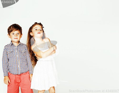 Image of little cute boy and girl hugging playing on white background, ha