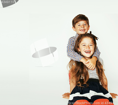 Image of little cute boy and girl hugging playing on white background, ha