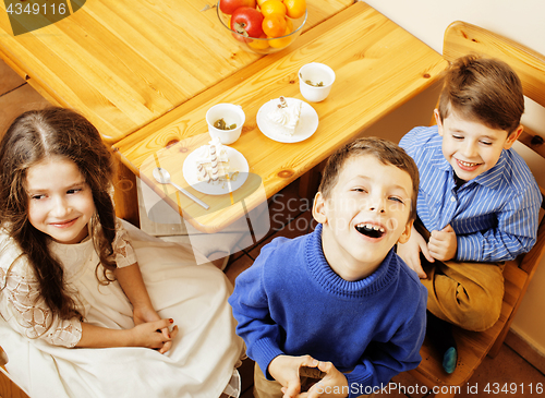 Image of little cute boys eating dessert on wooden kitchen. home interior. smiling adorable friendship together forever friends, lifestyle people concept 