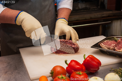 Image of Chef cutting meat