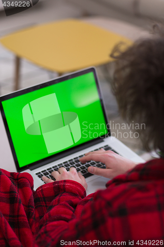 Image of man freelancer in bathrobe working from home