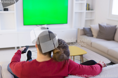 Image of Young couple on the sofa watching television