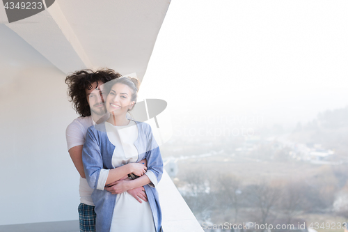 Image of Couple hugging on the balcony