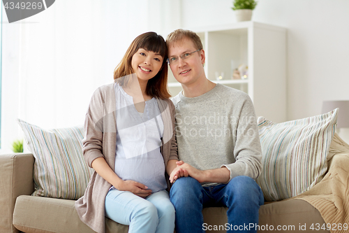 Image of happy pregnant wife with husband at home