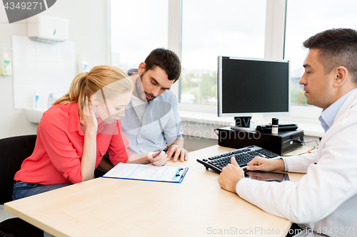 Image of couple visiting doctor at family planning clinic