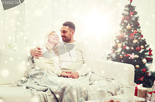 Image of happy couple at home with christmas tree