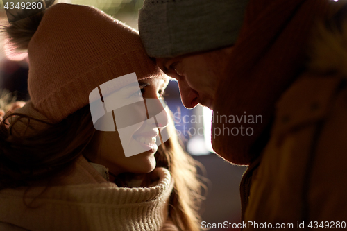 Image of close up of happy couple in winter clothes