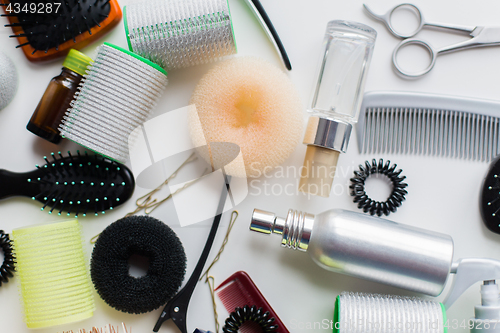 Image of hair donuts, styling sprays, curlers and pins