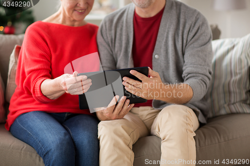 Image of senior couple with tablet pc at christmas