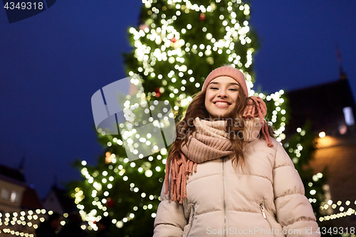 Image of happy young woman at christmas in winter