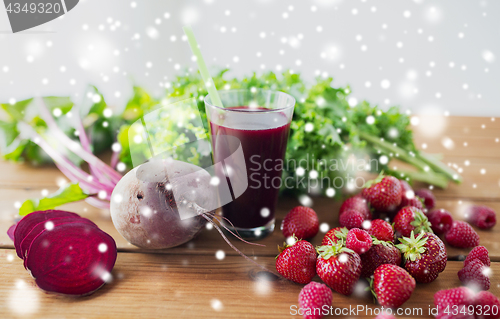 Image of glass of beetroot juice, berries and vegetables