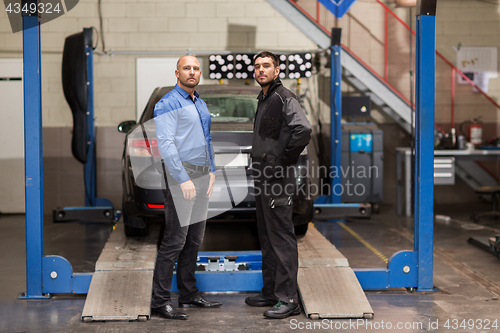 Image of auto mechanic and customer at car shop