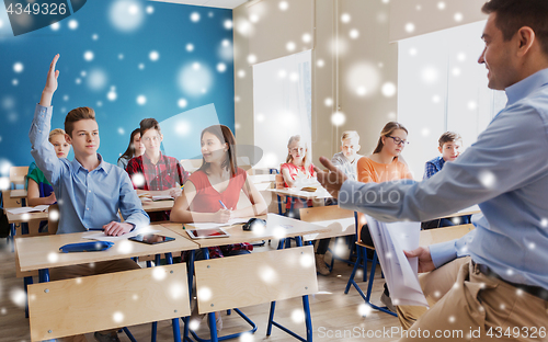 Image of group of students and teacher with papers or tests