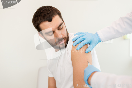 Image of male patient and doctor hands with syringe