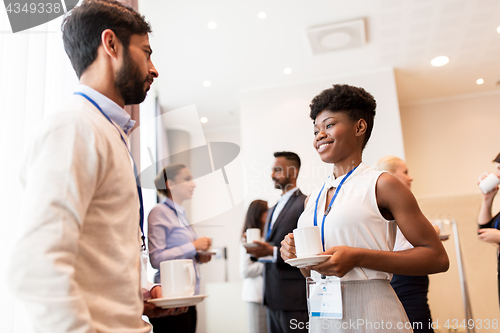 Image of business people with conference badges and coffee