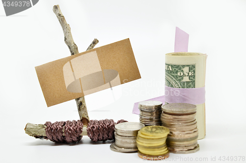 Image of Paper sign board with stack of coins