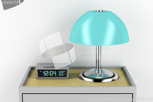 Image of Nightstand with alarm clock and lamp