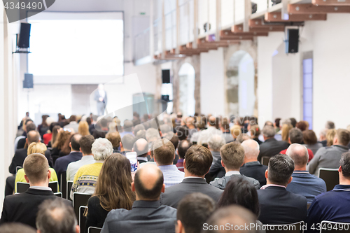 Image of Business speaker giving a talk at business conference event.