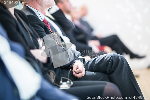 Image of Row of business people sitting at seminar.