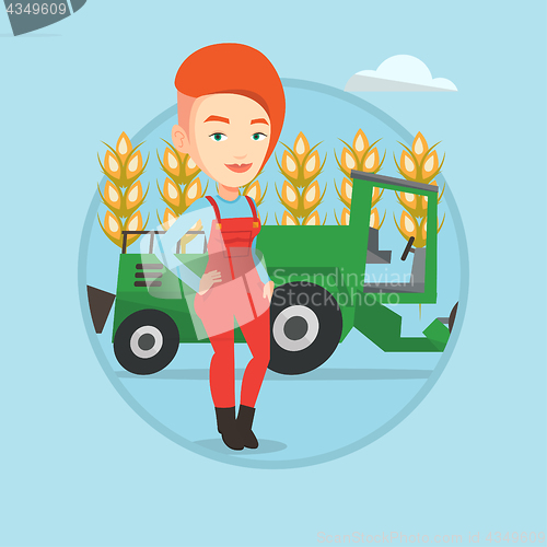 Image of Farmer standing with combine on background.