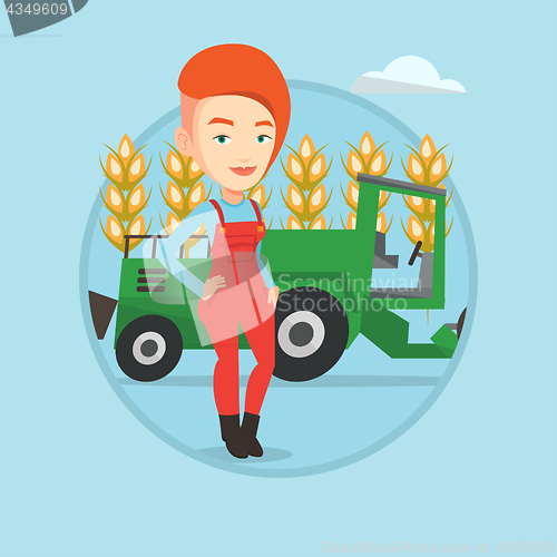 Image of Farmer standing with combine on background.