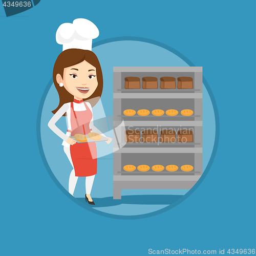 Image of Happy young female baker holding tray of bread.