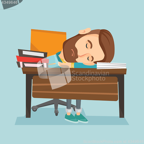 Image of Student sleeping at the desk with book.