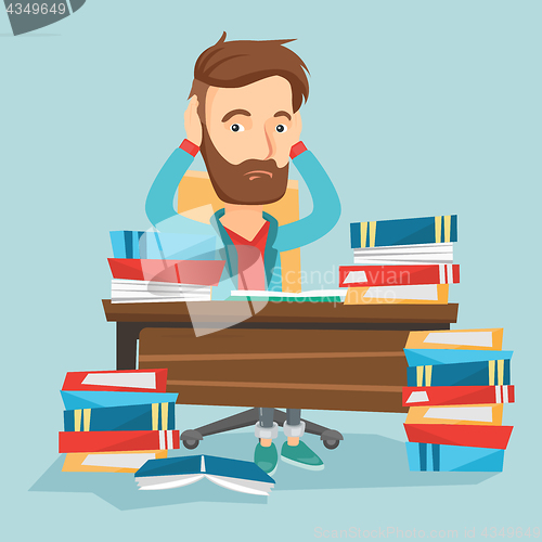 Image of Student sitting at the table with piles of books.